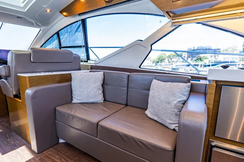 My Way Yacht Photos Pics Luxurious interior of 2019 Cruisers Yachts 54 Cantius with plush seating and large windows.