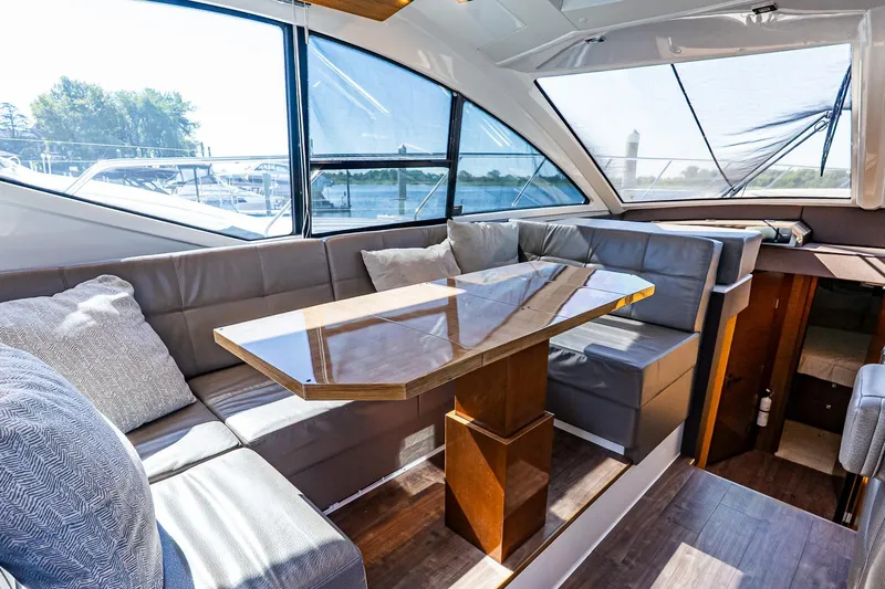 My Way Yacht Photos Pics Luxurious interior of 2019 Cruisers Yachts 54 Cantius with elegant seating and table.