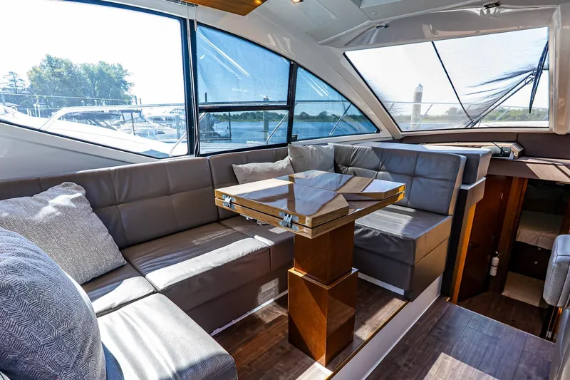 My Way Yacht Photos Pics Luxurious interior of 2019 Cruisers Yachts 54 Cantius with elegant seating and table.