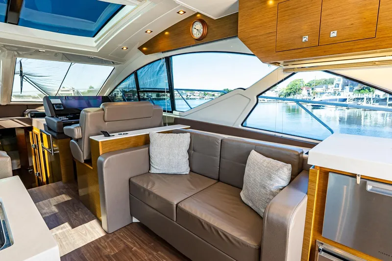 My Way Yacht Photos Pics Luxurious interior of 2019 Cruisers Yachts 54 Cantius with modern seating and large windows.