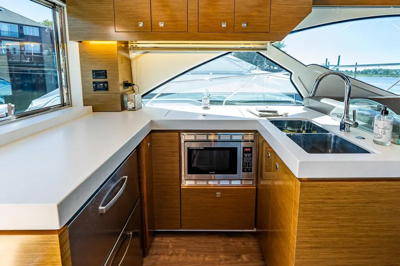 My Way Yacht Photos Pics Luxurious 2019 Cruisers Yachts 54 Cantius kitchen with modern appliances and sleek design.