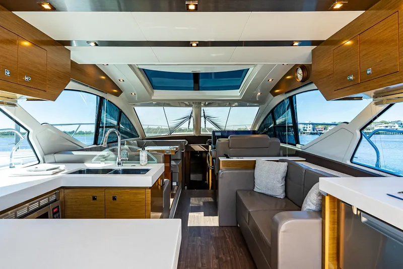 My Way Yacht Photos Pics Luxurious interior of 2019 Cruisers Yachts 54 Cantius with modern kitchen and seating area.