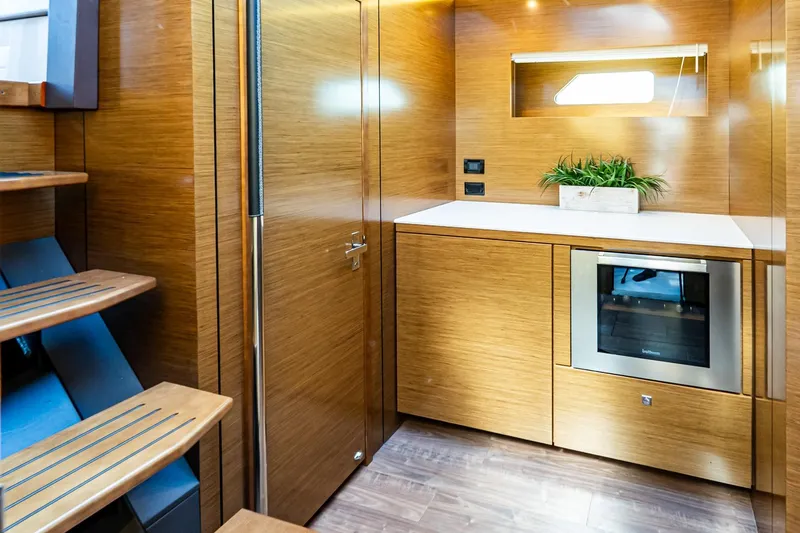 My Way Yacht Photos Pics Luxurious 2019 Cruisers Yachts 54 Cantius interior with modern wood finish and built-in oven.