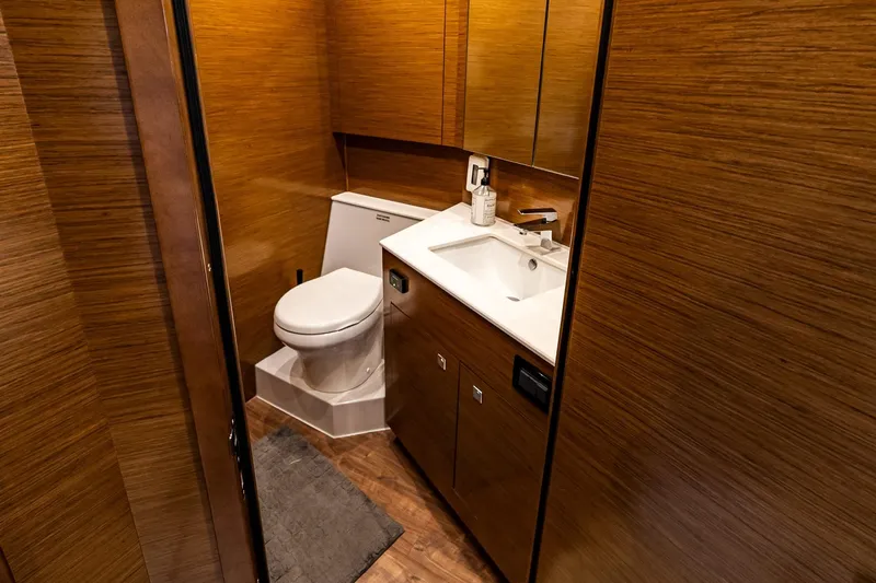 My Way Yacht Photos Pics Luxurious 2019 Cruisers Yachts 54 Cantius bathroom with wood paneling and modern fixtures.