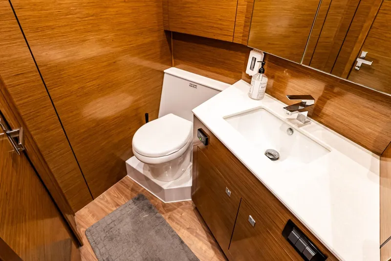 My Way Yacht Photos Pics Luxurious bathroom in 2019 Cruisers Yachts 54 Cantius with modern fixtures and wood accents.