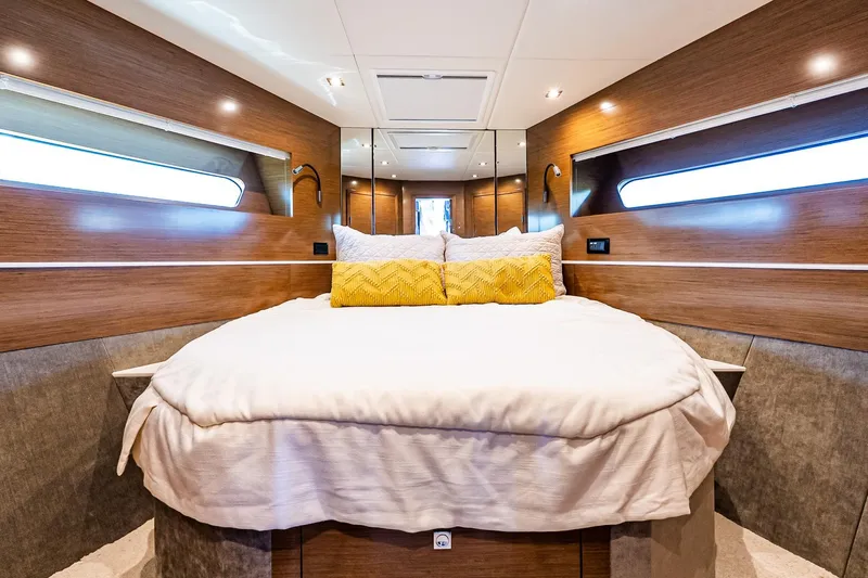 My Way Yacht Photos Pics Luxurious bedroom interior of 2019 Cruisers Yachts 54 Cantius with modern wood paneling.