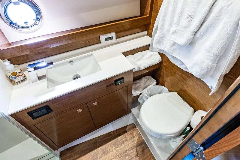 My Way Yacht Photos Pics Luxurious bathroom in 2019 Cruisers Yachts 54 Cantius, featuring modern fixtures and elegant wood finishes.