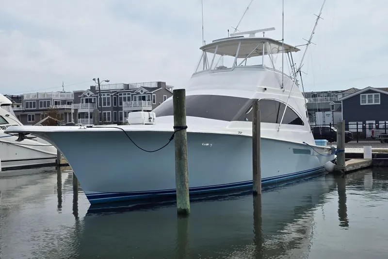  Yacht Photos Pics 2004 Ocean Yachts 50 Super Sport docked in a marina, with waterfront homes in the background.