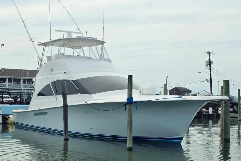  Yacht Photos Pics 2004 Ocean Yachts 50 Super Sport docked at a marina, showcasing sleek design and fishing equipment.