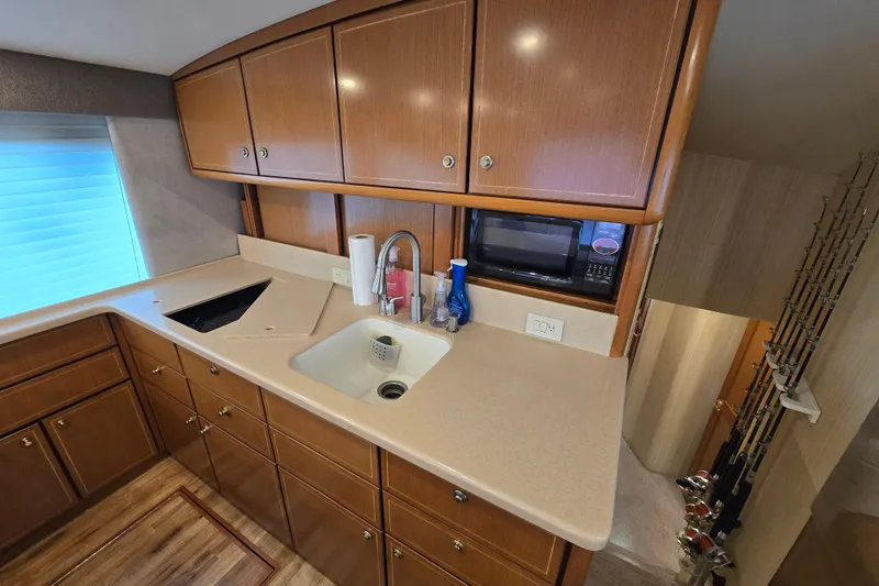  Yacht Photos Pics 2004 Ocean Yachts 50 Super Sport kitchen with wooden cabinets and modern appliances.