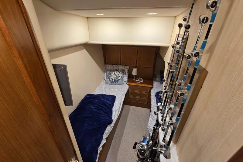  Yacht Photos Pics 2004 Ocean Yachts 50 Super Sport cabin with twin beds and fishing rods.
