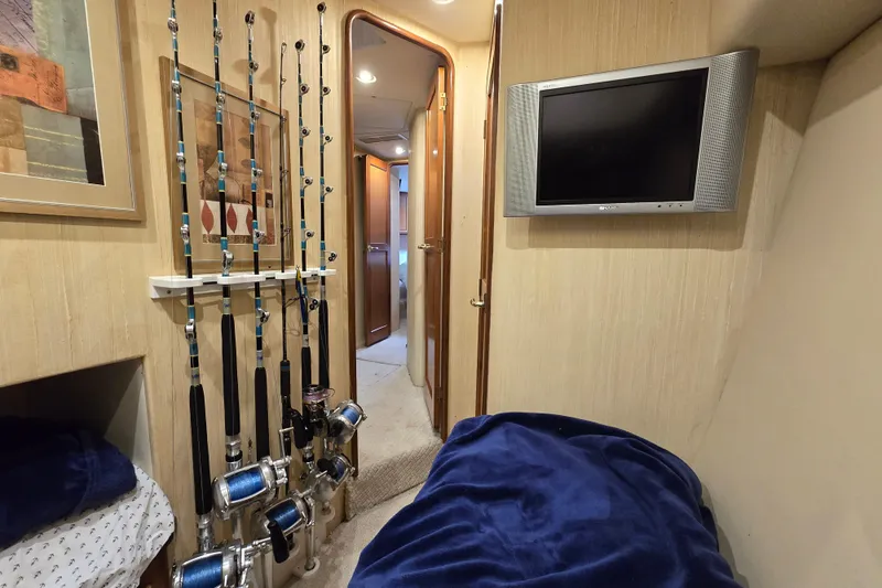  Yacht Photos Pics 2004 Ocean Yachts 50 Super Sport cabin with fishing rods and wall-mounted TV.