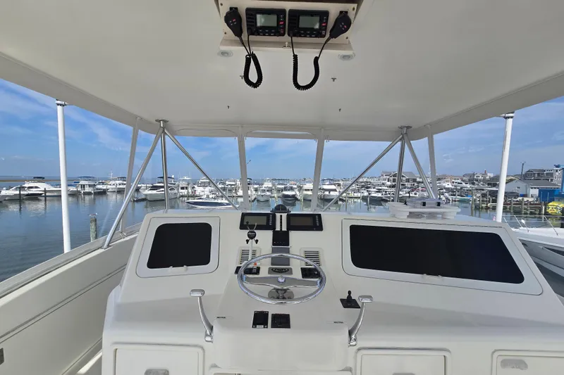  Yacht Photos Pics Helm of 2004 Ocean Yachts 50 Super Sport overlooking marina with docked boats.