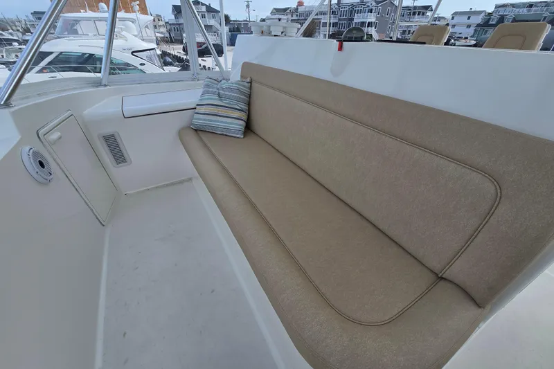  Yacht Photos Pics 2004 Ocean Yachts 50 Super Sport boat seating area with cushion and striped pillow.