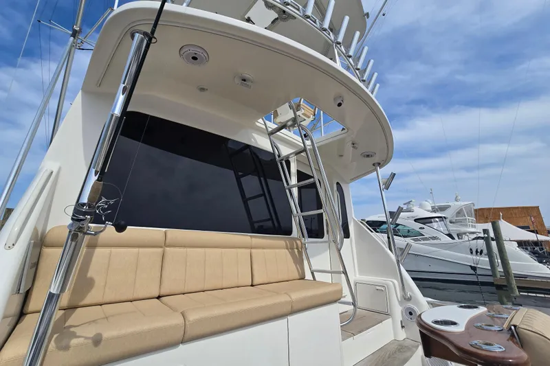  Yacht Photos Pics 2004 Ocean Yachts 50 Super Sport with beige seating and fishing equipment at a marina.