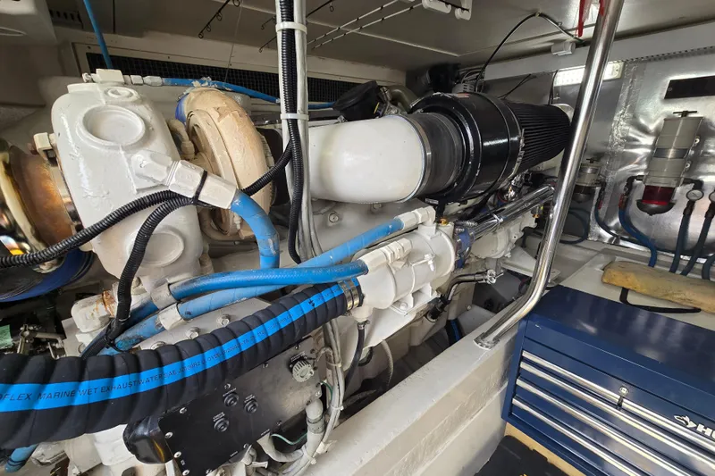  Yacht Photos Pics Engine room of 2004 Ocean Yachts 50 Super Sport with visible components and blue hoses.