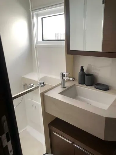  Yacht Photos Pics Modern bathroom in 2021 Lagoon 46 yacht with sleek sink and shower.