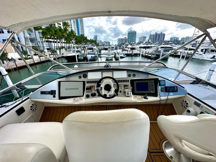 Big Daddy Yacht Photos Pics 2007 Marquis 59 Markham Edition yacht helm with marina view, featuring Garmin navigation.