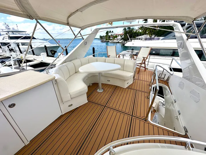 Big Daddy Yacht Photos Pics Luxurious 2007 Marquis 59 Markham Edition yacht deck with seating and ocean view.