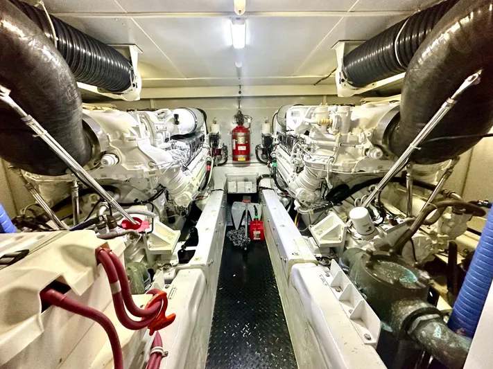 Big Daddy Yacht Photos Pics Engine room of 2007 Marquis 59 Markham Edition yacht with dual engines and fire extinguisher.