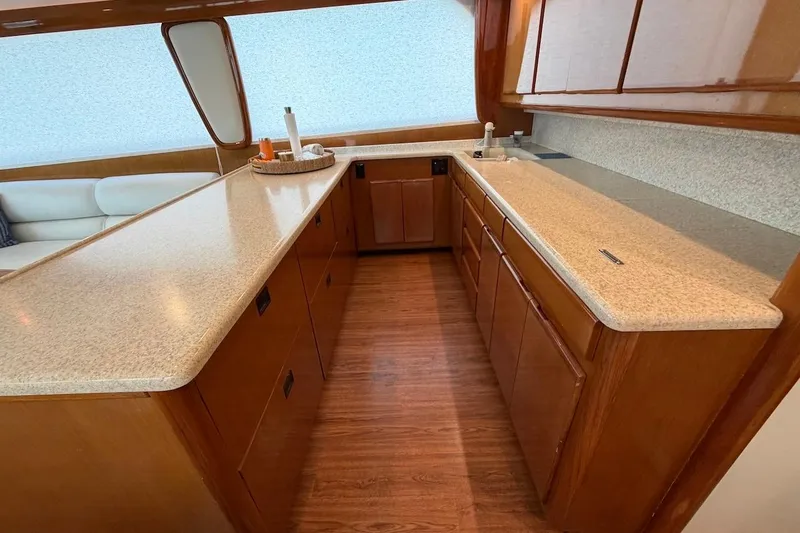 Maritere Yacht Photos Pics Luxurious kitchen interior of 1999 Viking 58 Convertible yacht with wooden cabinetry.