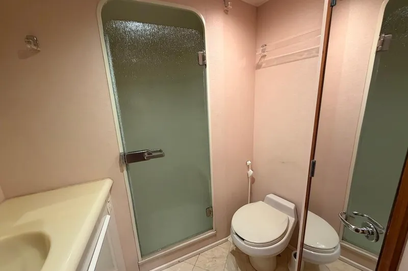 Maritere Yacht Photos Pics Bathroom interior of 1999 Viking 58 Convertible yacht with shower and toilet.