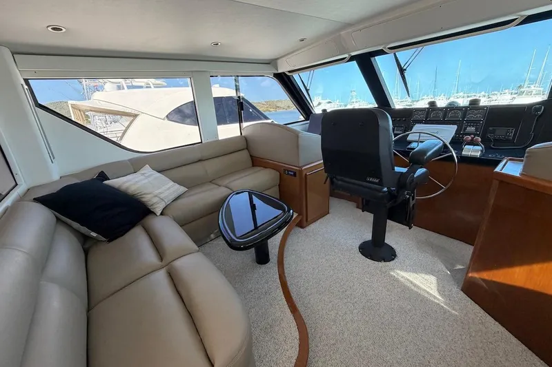 Maritere Yacht Photos Pics Luxurious interior of 1999 Viking 58 Convertible yacht with plush seating and helm.