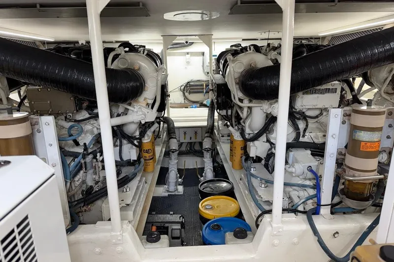 Maritere Yacht Photos Pics Engine room of a 1999 Viking 58 Convertible yacht, showcasing dual engines and components.