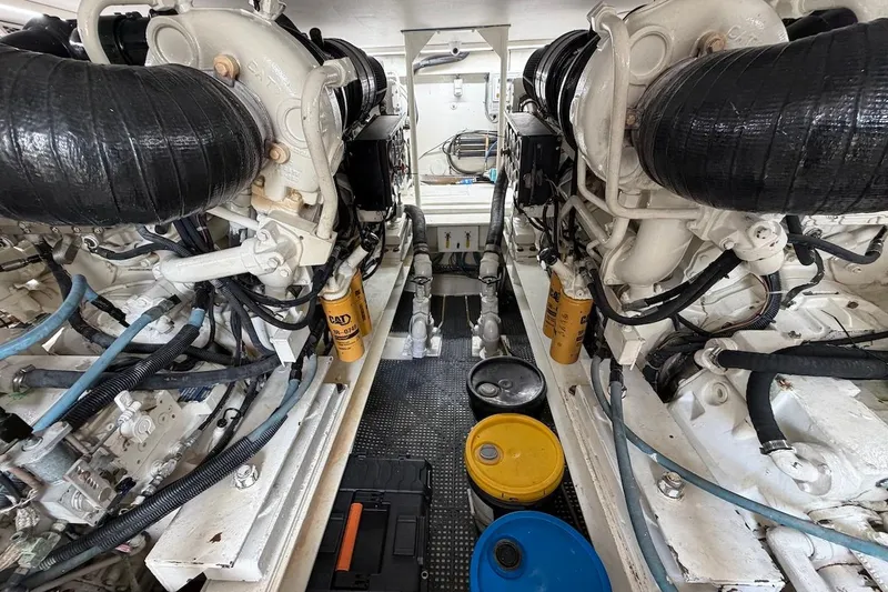 Maritere Yacht Photos Pics Engine room of a 1999 Viking 58 Convertible yacht, showcasing dual engines and maintenance equipment.