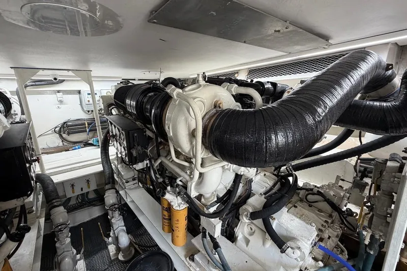 Maritere Yacht Photos Pics Engine room of a 1999 Viking 58 Convertible yacht, showcasing detailed machinery and components.