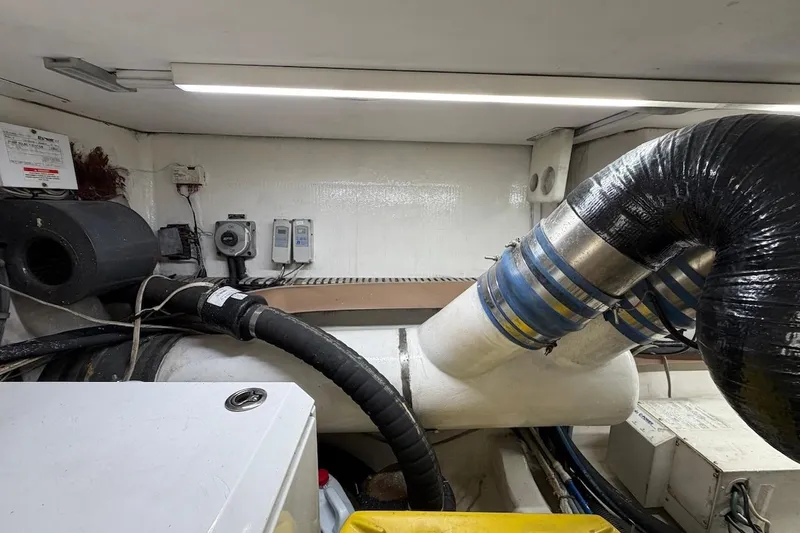 Maritere Yacht Photos Pics Engine room of a 1999 Viking 58 Convertible yacht with visible exhaust system and wiring.