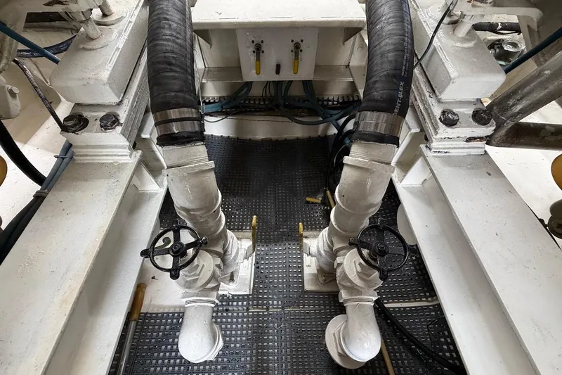 Maritere Yacht Photos Pics Engine room of 1999 Viking 58 Convertible yacht with visible piping and valves.