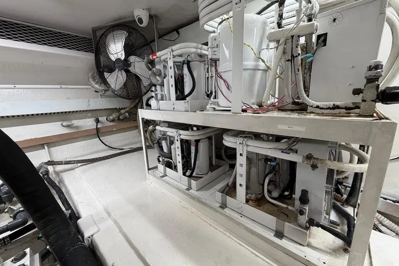Maritere Yacht Photos Pics Engine room of a 1999 Viking 58 Convertible yacht, featuring machinery and ventilation.
