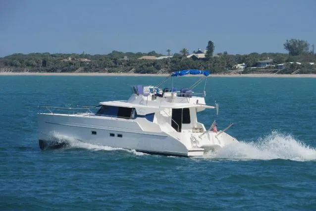 Sometimes Nancy Yacht Photos Pics 2003 Fountaine Pajot Maryland 37 cruising on blue ocean near coastline.