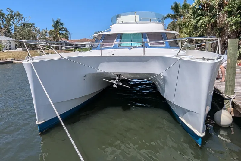 Sometimes Nancy Yacht Photos Pics 2003 Fountaine Pajot Maryland 37 catamaran docked by palm trees.