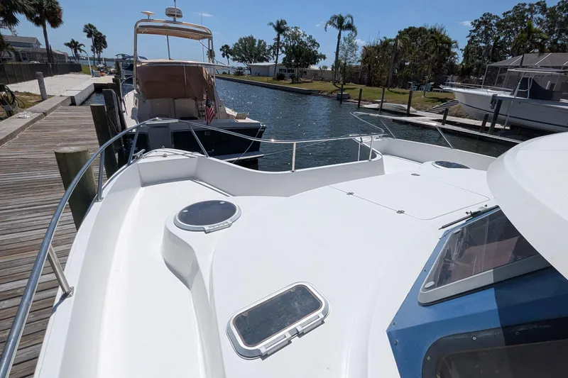 Sometimes Nancy Yacht Photos Pics 2003 Fountaine Pajot Maryland 37 yacht docked at a marina, sunny day, palm trees.