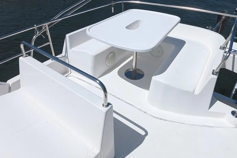 Sometimes Nancy Yacht Photos Pics 2003 Fountaine Pajot Maryland 37 boat deck with seating and table, overlooking water.