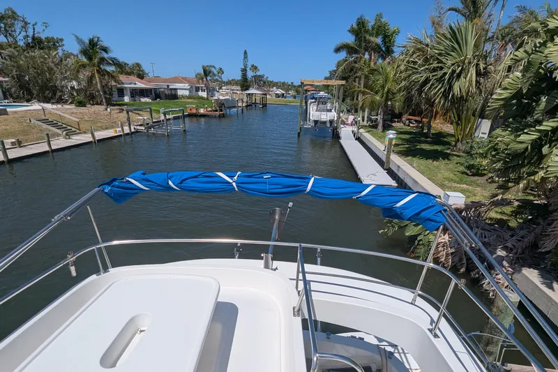Sometimes Nancy Yacht Photos Pics 2003 Fountaine Pajot Maryland 37 yacht navigating a scenic canal with lush greenery.