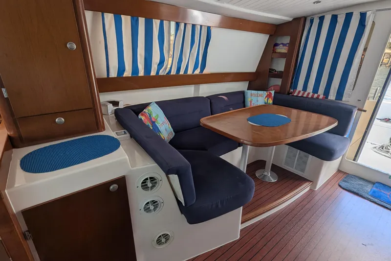 Sometimes Nancy Yacht Photos Pics Interior of 2003 Fountaine Pajot Maryland 37 with blue seating and striped curtains.