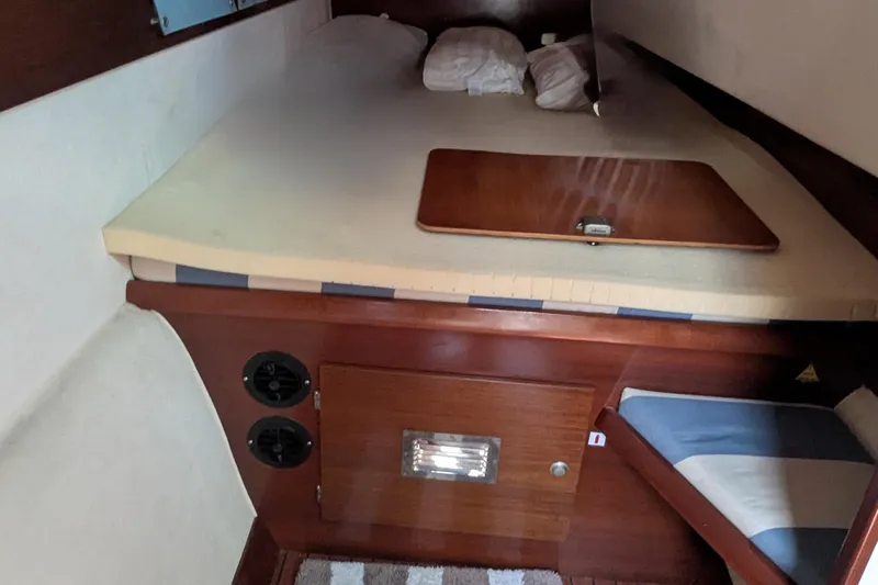 Sometimes Nancy Yacht Photos Pics 2003 Fountaine Pajot Maryland 37 cabin interior with bed and wooden storage.