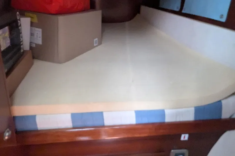 Sometimes Nancy Yacht Photos Pics Cabin interior of 2003 Fountaine Pajot Maryland 37 with storage boxes on bed.