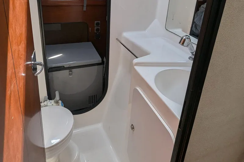 Sometimes Nancy Yacht Photos Pics Bathroom interior of 2003 Fountaine Pajot Maryland 37 yacht, featuring sink and toilet.