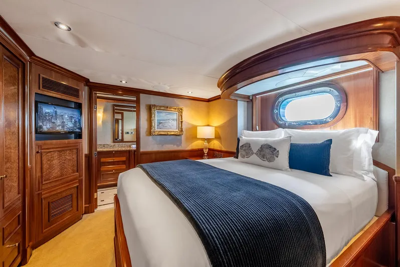 Calliope Yacht Photos Pics Luxurious bedroom in 2007 Richmond Yachts Semi Displacement, featuring elegant wood finishes and cozy bedding.