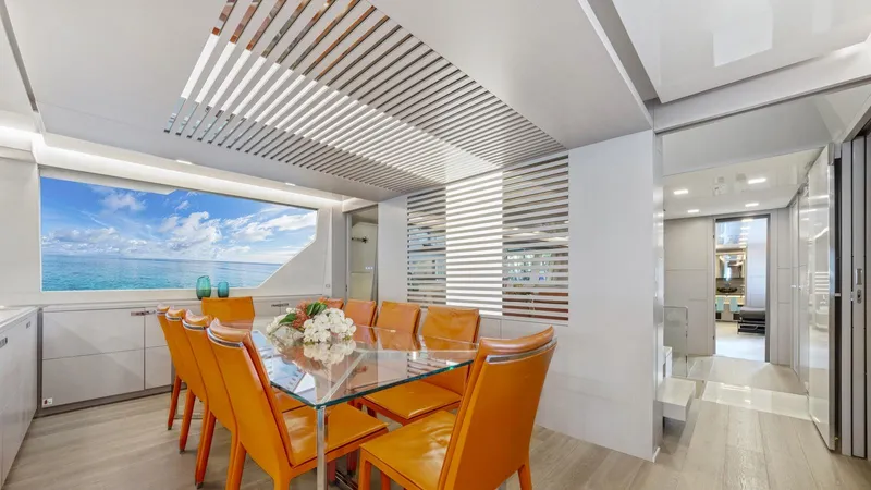 Chitochi Yacht Photos Pics Luxurious yacht dining area with ocean view, featuring orange chairs and modern decor, 2016 Ferretti Group.