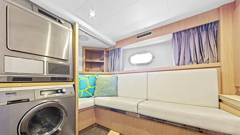 Chitochi Yacht Photos Pics Luxurious yacht interior with seating, washing machine, and porthole window, Custom Line Ferretti Group 2016.