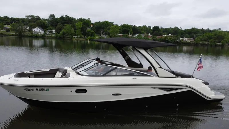  Yacht Photos Pics 2017 Sea Ray SLX 280 boat cruising on a calm lake with lush green shoreline.
