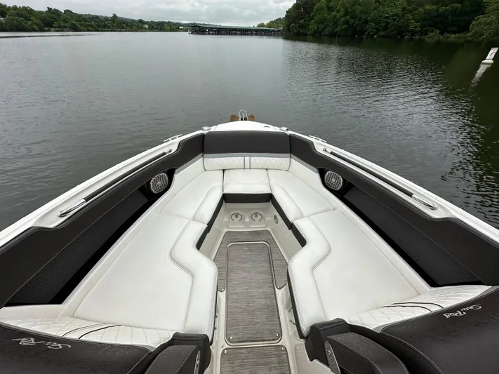  Yacht Photos Pics 2017 Sea Ray SLX 280 boat interior with white seating on a calm lake.