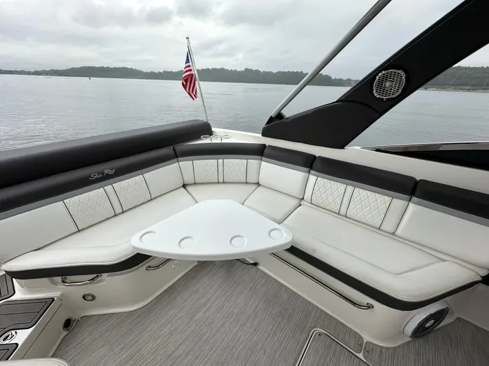  Yacht Photos Pics 2017 Sea Ray SLX 280 boat interior with seating and table, on a calm lake.