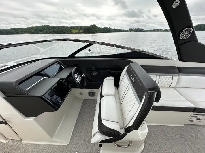  Yacht Photos Pics 2017 Sea Ray SLX 280 boat interior with sleek dashboard and comfortable seating on a calm lake.
