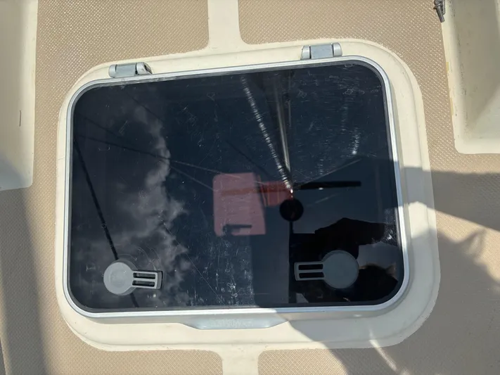 Island Girl Yacht Photos Pics Hatch on 1990 Island Packet 38 sailboat deck, reflecting sky and rigging.